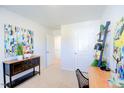 Bright bedroom with a desk, dresser, and colorful artwork at 513 Fife Ct, Gibsonville, NC 27249