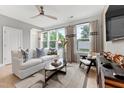 Bright living room with large windows, comfy seating, and stylish decor at 604 Market Grove Dr # 100, Wake Forest, NC 27587