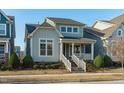 Two-story light blue house with white trim and a brick walkway at 6417 Truxton Ln, Raleigh, NC 27616