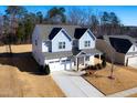 Two-story house with gray and beige siding, driveway, and yard at 78 N Porcenna Ln, Clayton, NC 27527