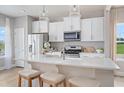 Modern kitchen with white cabinets, island, and stainless steel appliances at 2018 Cross Bones Blvd # 28, Durham, NC 27703