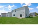 View of the home's back and side with a grassy yard at 273 Hanging Elm Ln, Fuquay Varina, NC 27526