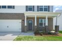Gray front door entry with brick columns and landscaping at 273 Hanging Elm Ln, Fuquay Varina, NC 27526