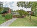 Inviting pool area with brick wall, steps, and surrounding landscaping at 304 Homestead Rd. Rd, Chapel Hill, NC 27516