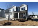 Two-story home with gray siding, white accents, and a two-car garage at 453 Edison Rail Ln, Knightdale, NC 27545