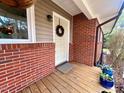 Welcoming front entrance with a white door, brick exterior, potted plants, and a door wreath at 1120 Northview St, Garner, NC 27529