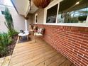 Inviting front porch with seating, brick accents, and decorative plants at 1120 Northview St, Garner, NC 27529