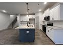Spacious kitchen with ample counter space, stainless steel appliances, and a view of the staircase at 136 S Mistflower St, Clayton, NC 27520