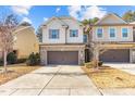 Two-story townhome with brick and siding exterior, attached garage, and landscaping at 154 Alamosa Pl, Cary, NC 27519