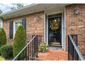 Close-up of the home's entrance, featuring a black door with a decorative wreath at 421 Weathergreen Dr, Raleigh, NC 27615