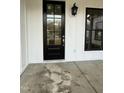 Inviting front porch with a black front door and sidelights at 601 Vannoy Pl, Fuquay Varina, NC 27526