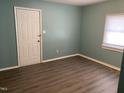 Light-blue bedroom with wood floors and a closet at 703 Lee St, Durham, NC 27701