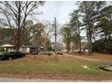 One-story house situated on a corner lot with trees at 923 Sunny Ln, Raleigh, NC 27603