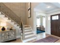 Grand foyer with a staircase, hardwood floors, and access to adjacent rooms at 9520 Wood River Dr, Zebulon, NC 27597