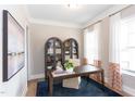 Home office or study with elegant cabinetry, a large desk, and decorative curtains at 9520 Wood River Dr, Zebulon, NC 27597