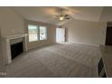 Spacious living room with fireplace, ceiling fan, and plush carpet at 193 Magnolia Run Way, Benson, NC 27504