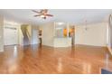 Open-concept living area with hardwood flooring, ceiling fan, and view of the kitchen at 2204 Regent Ct, Creedmoor, NC 27522