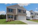 New two-story home with stone accents, front porch, and attached two-car garage at 432 Ashley Run, Sanford, NC 27330