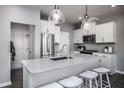 Modern kitchen featuring white cabinets, stainless steel appliances, and an island with seating at 800 Mckenzie Park Ter, Wendell, NC 27591