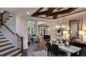 Elegant dining room with chandelier, hardwood floors, and view to living room at 259 August Trce Dr, Pittsboro, NC 27312