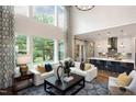 Open concept living room with kitchen, high ceilings, and large windows at 259 August Trce Dr, Pittsboro, NC 27312