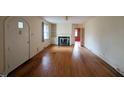 Living room featuring hardwood floors, fireplace, built-in shelves, and arched doorway at 2705 Royster St, Raleigh, NC 27608