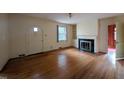 Living room with hardwood floors, a fireplace, built-in shelves, and an arched doorway at 2705 Royster St, Raleigh, NC 27608