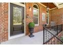 Inviting front porch with black door and planter at 3423 Iva Ada Dr, Hillsborough, NC 27278