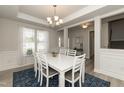 Elegant dining room with white table and blue rug at 596 Ravensworth Dr, Garner, NC 27529