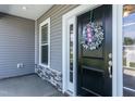 Inviting front entrance with black door and stone accents at 596 Ravensworth Dr, Garner, NC 27529