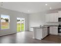 Open kitchen with white cabinetry, a granite-topped island, and stainless steel appliances at 604 Rhino Bnd, Oxford, NC 27565