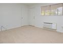 Bright living room featuring carpet and a door at 130 S Estes Dr # G5, Chapel Hill, NC 27514