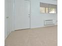 Simple living room with carpet, door, and window at 130 S Estes Dr # G5, Chapel Hill, NC 27514