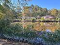 Houses on a peaceful waterfront with lush trees at 130 S Estes Dr # G5, Chapel Hill, NC 27514