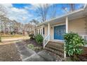 Home entrance with blue door and brick steps leading to porch at 312 Burkwood Ln, Raleigh, NC 27609