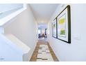 Bright entryway with hardwood floors, staircase, and artwork at 301 Cherry Laurel Dr, Sanford, NC 27332