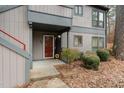 Condo building entrance with red door and landscaping at 42 Melstone Turn, Durham, NC 27707