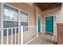 Teal front door with welcome mat and wood deck at 524 Glenolden Ct, Cary, NC 27513