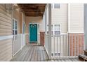 Teal front door and wood deck with white railings at 524 Glenolden Ct, Cary, NC 27513