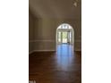Bright and spacious entryway with hardwood floors and arched doorway leading to the back of the house at 6101 Valentine St, Zebulon, NC 27597