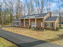 Ranch style brick house with a long driveway and landscaping at 191 Pine Lake Dr, Siler City, NC 27344