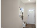 Front entry with staircase, hardwood floors, and neutral wall colors at 454 Belgian Red Way, Wake Forest, NC 27587