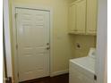Laundry room with washer, dryer and built-in cabinets at 513 Port Dr, Henderson, NC 27537