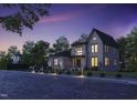 Modern house exterior at dusk with landscape lighting at 684 Golfers Vw, Pittsboro, NC 27312