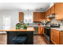 Eat-in kitchen with wood cabinets, stainless steel appliances, and an island at 722 Blue Lake Dr, Mebane, NC 27302