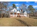 Brick home with a large front porch and 2 car garage at 101 Creekside Dr, Selma, NC 27576