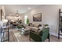 Open living room with a neutral color scheme and kitchen view at 2704 Ashley St # A, Durham, NC 27704