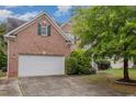 Two-car garage with a basketball hoop in the driveway at 4911 Stockton Way, Durham, NC 27707