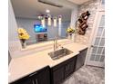 Kitchen features a breakfast bar with a wine rack and stainless steel sink at 5705 Katha Dr, Holly Springs, NC 27540