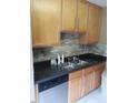 Kitchen features double sink and wood cabinets at 9908 Grettle Ct, Raleigh, NC 27617